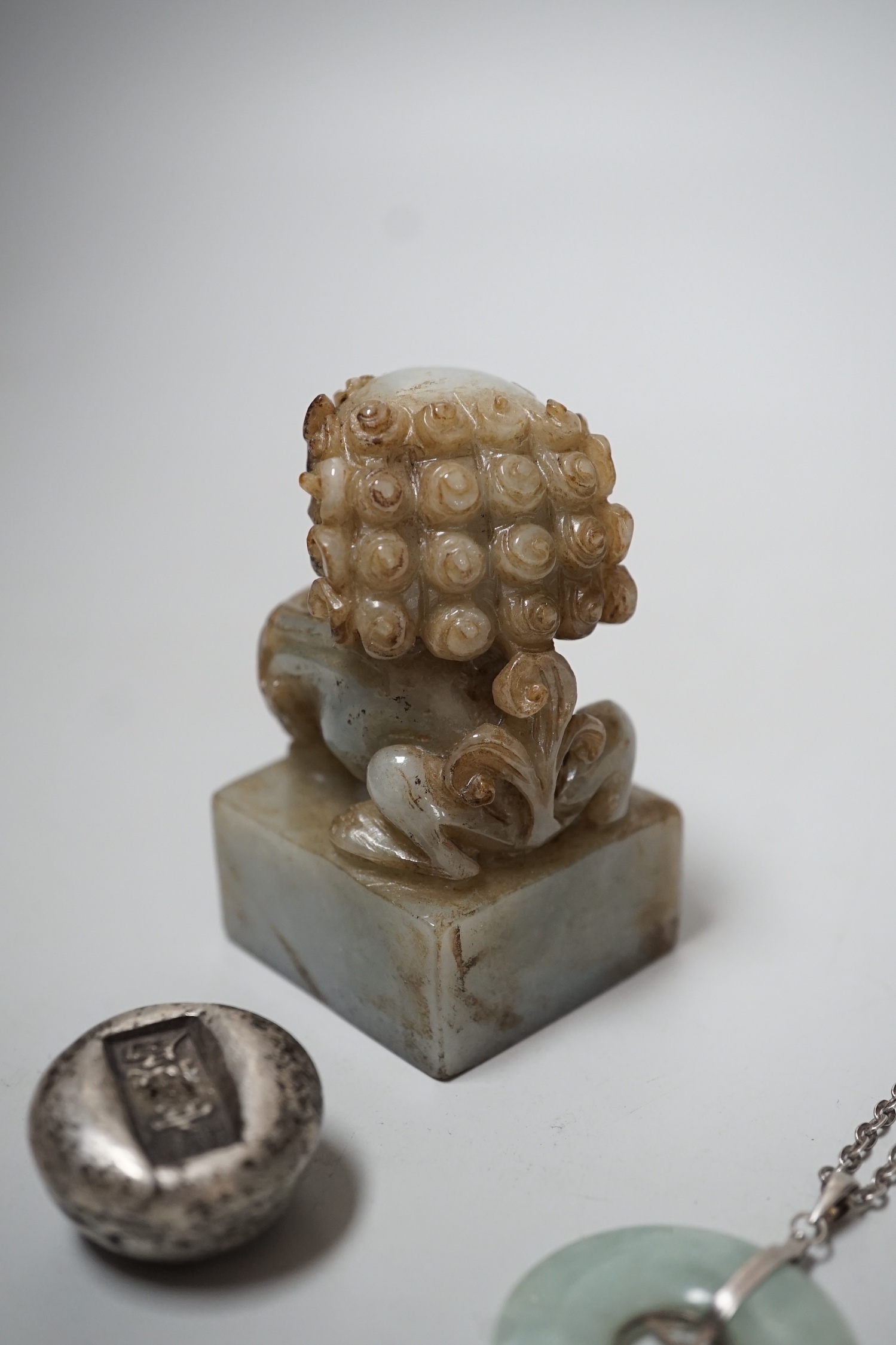 A Chinese jadeite lion-dog seal (black matrix), a similar pendant and two ingots